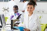 young man and woman in a lab woman in front of a microscope