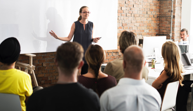 Woman speaking in front of a group